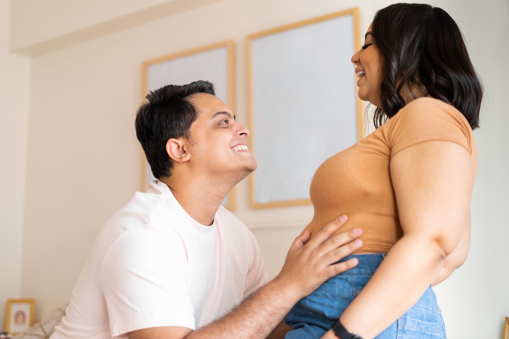 couple smiling over pregnancy announcement - how to tell your husband you're pregnant