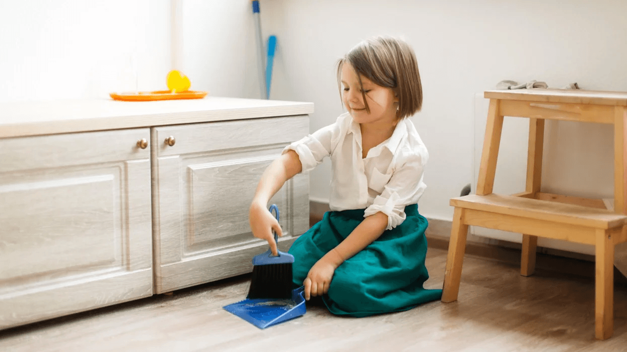 girl sweeping montessori at home 1 Motherly