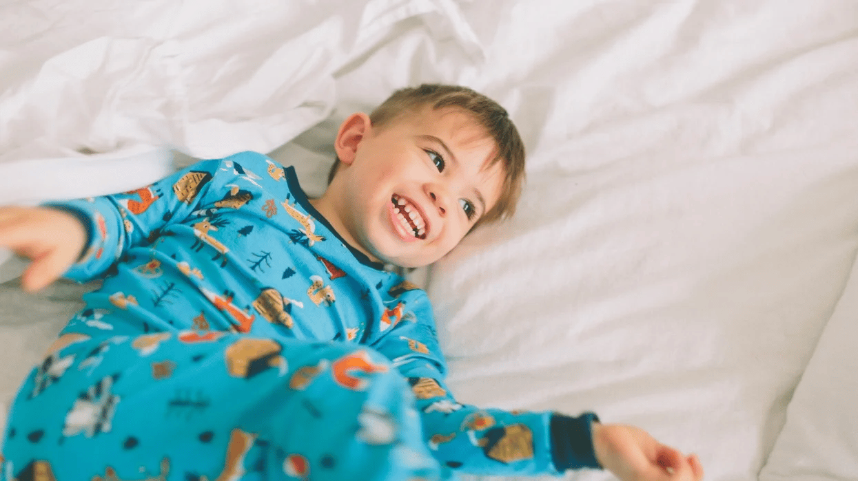 little boy playing in a bed