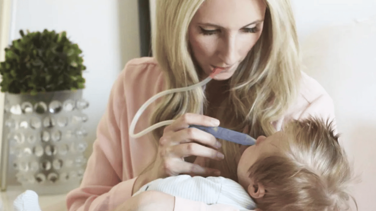 mom using fridababy nosefrida for baby's first cold