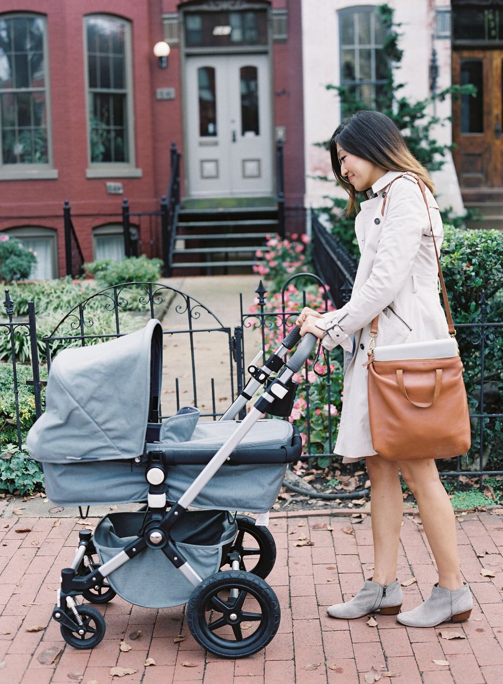 woman smiling at baby in stroller, preparing for daycare transition