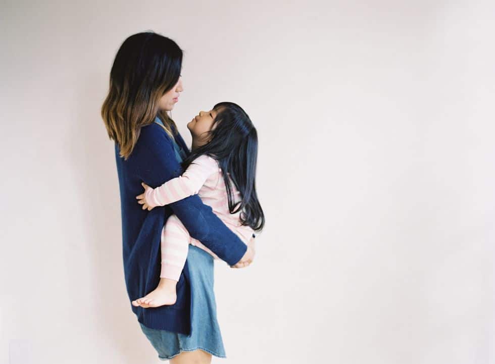 mom holding child, preparing for the daycare transition