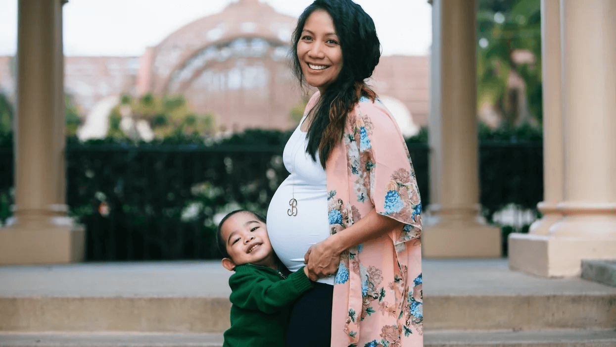 Pregnant mom hugging a toddler