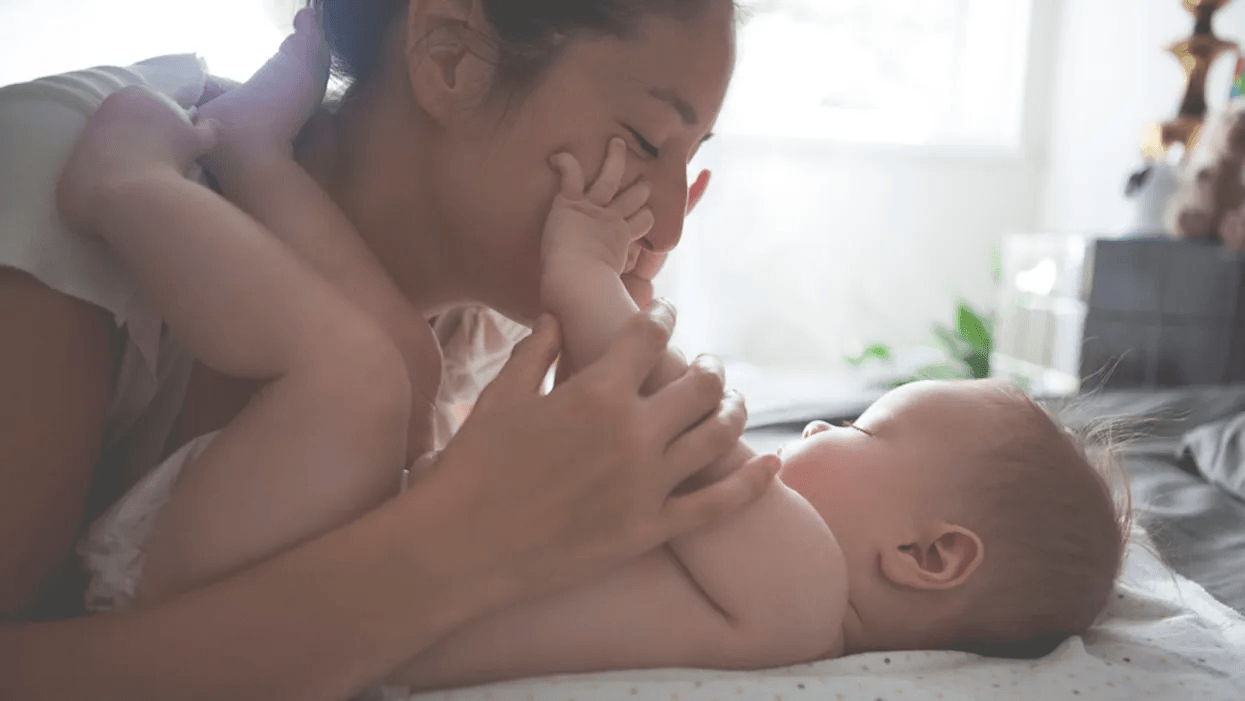 mom kissing baby's hands