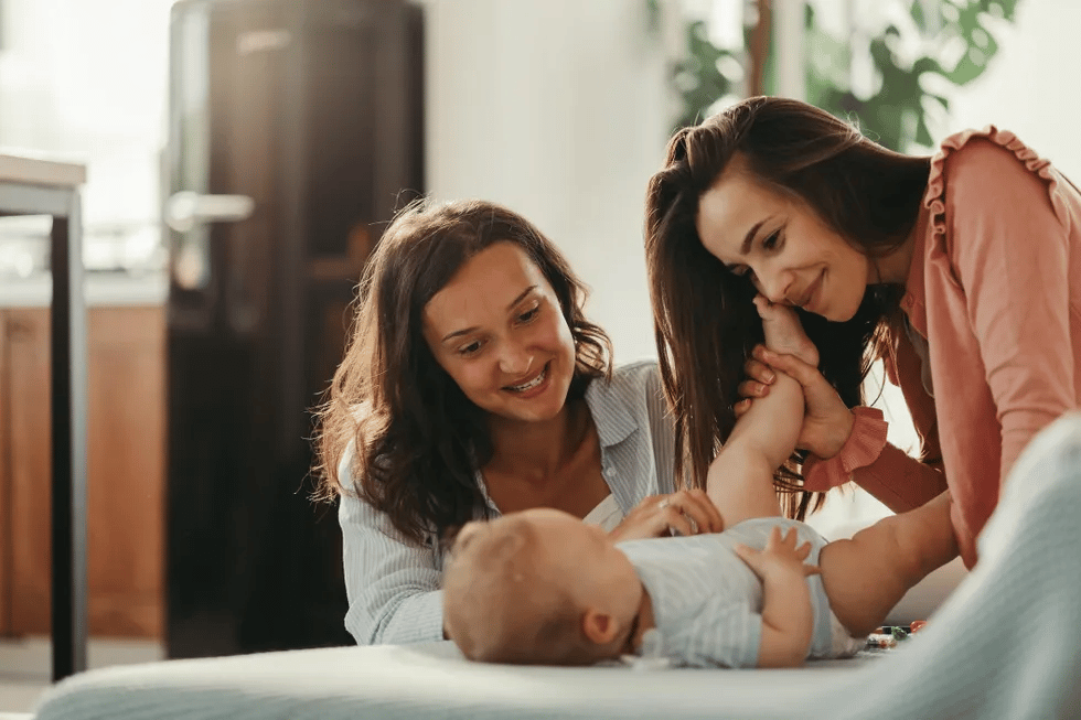 lgbtq family with baby at home - lgbtq family building