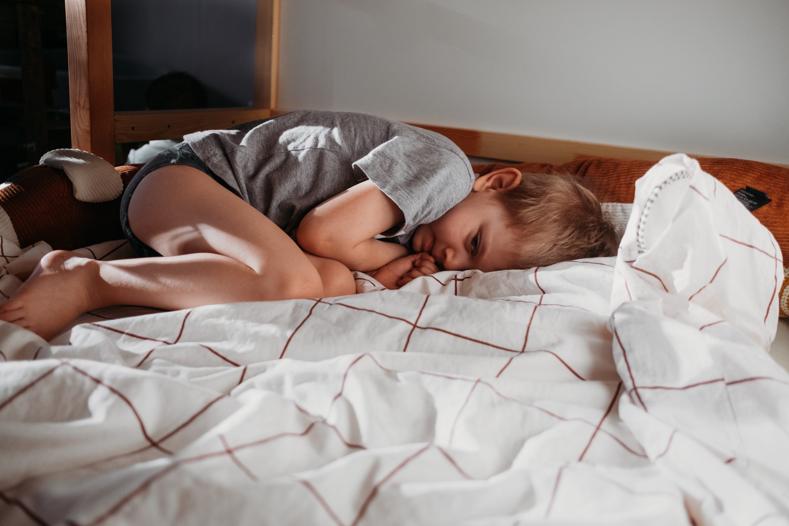 little sad boy kid laying in bed child in depression t20 xXldZ1 scaled