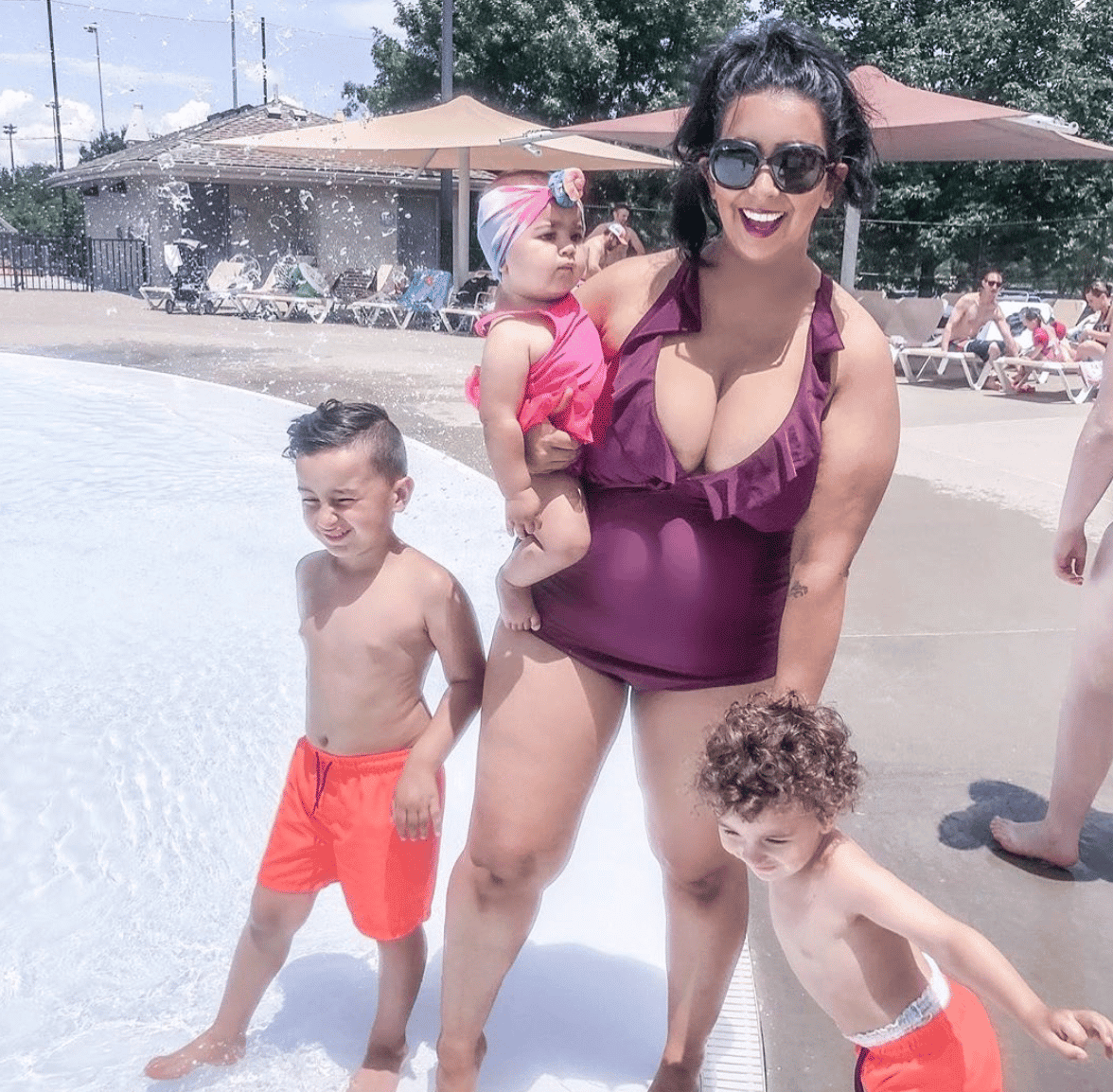 mom at a pool with her 3 kids