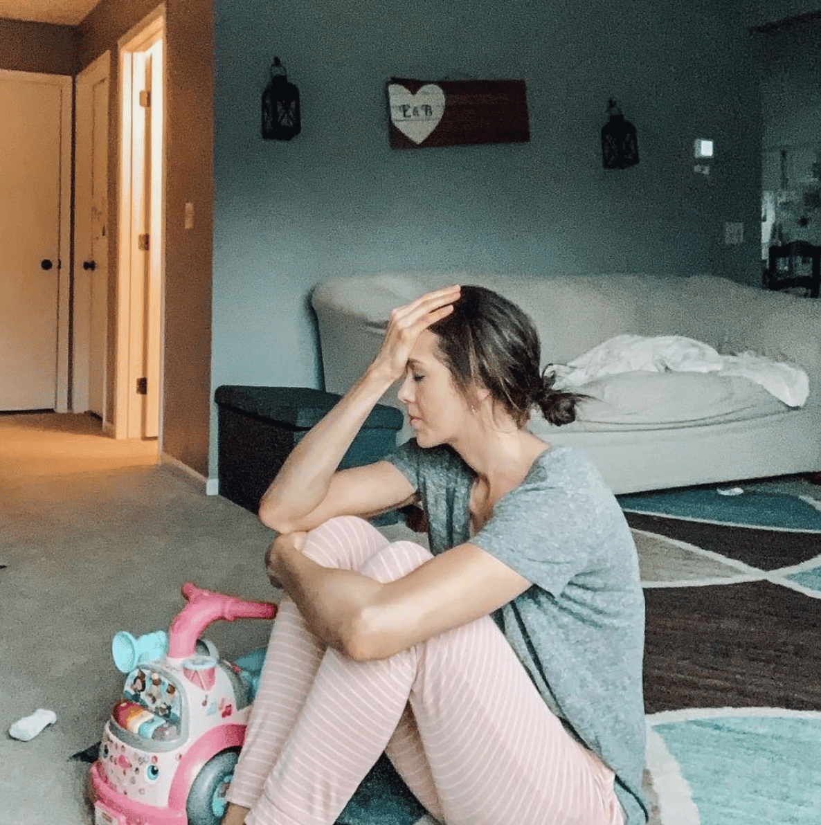 mom sitting on the floor with head in her hands