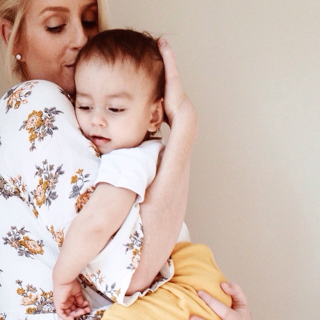 mom comforting child against her shoulder