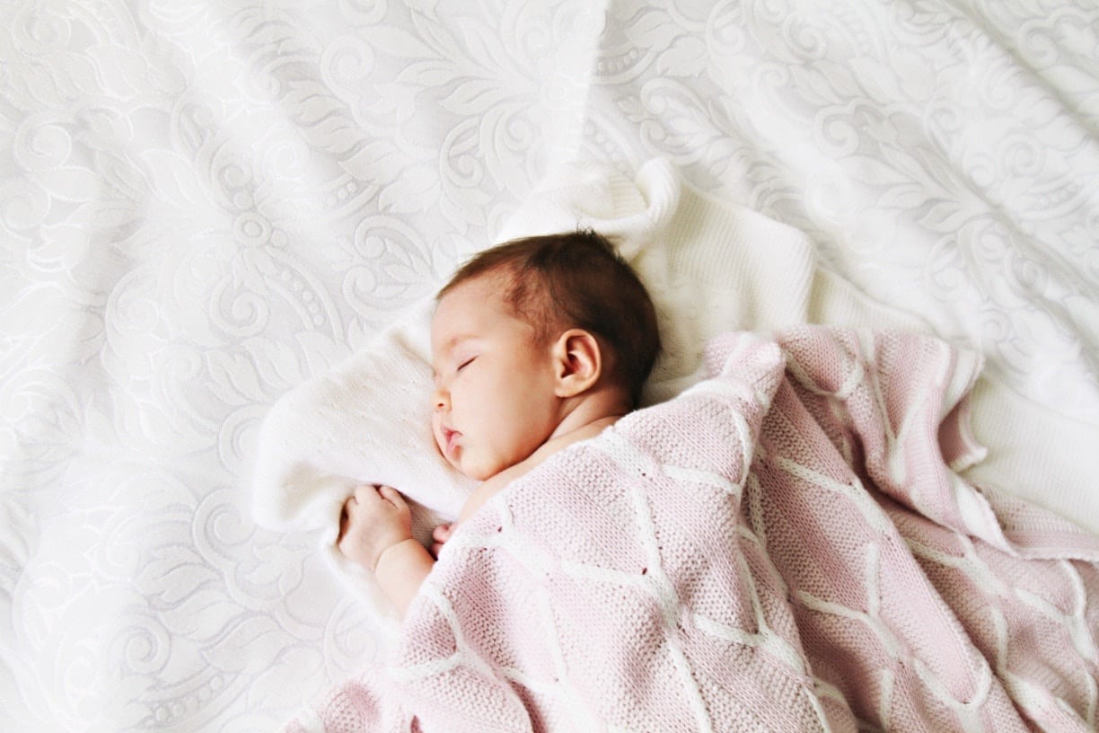 baby sleeping on a blanket