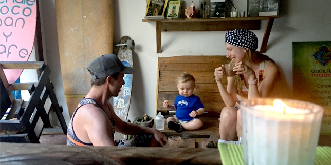 family traveling with baby, eating in restaurant