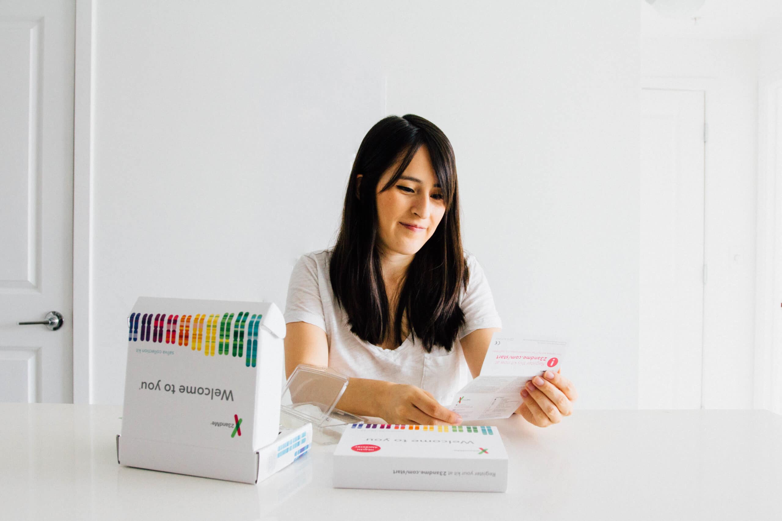 woman looking at 23andMe kit