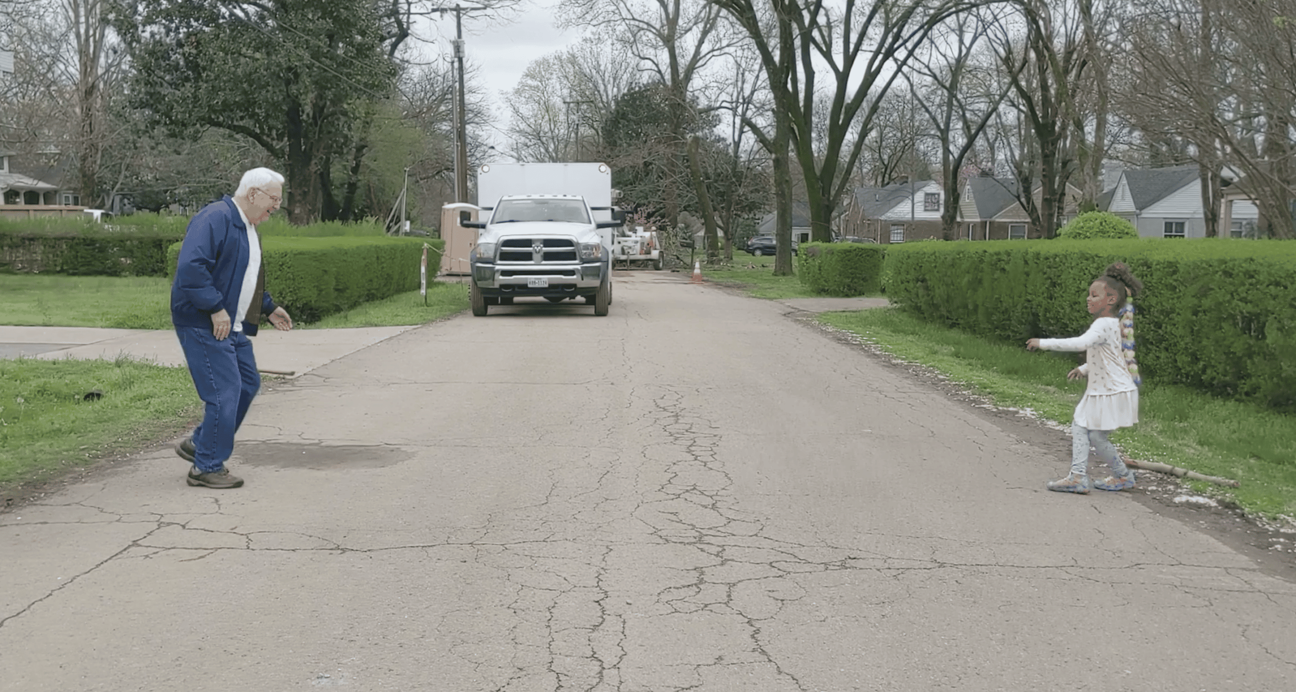 grandpa and granddaughter dancing in the road