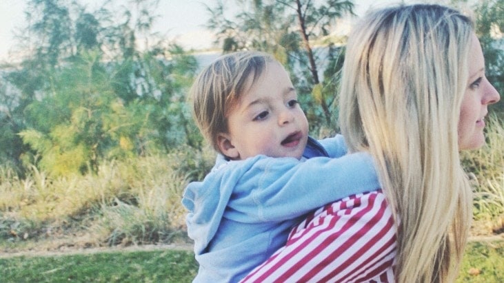 woman carrying toddler on her back