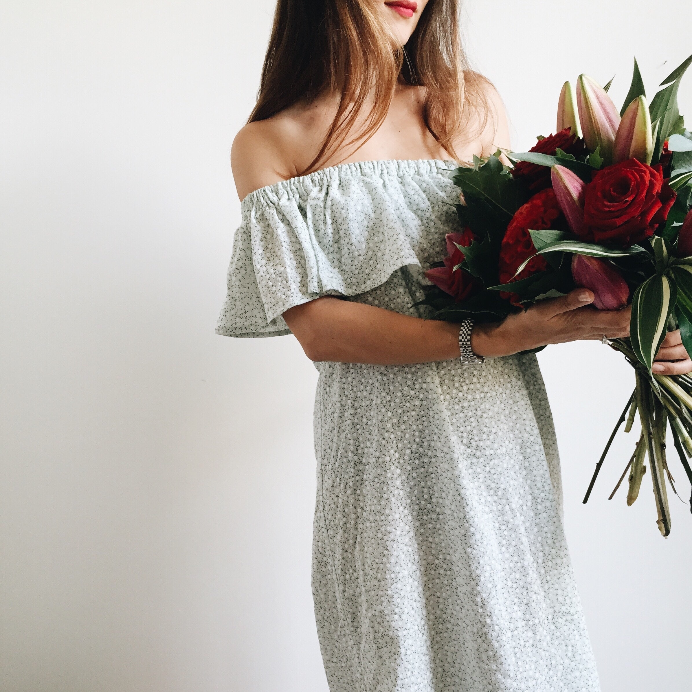 woman holding bouquet of flowers - self-care questions