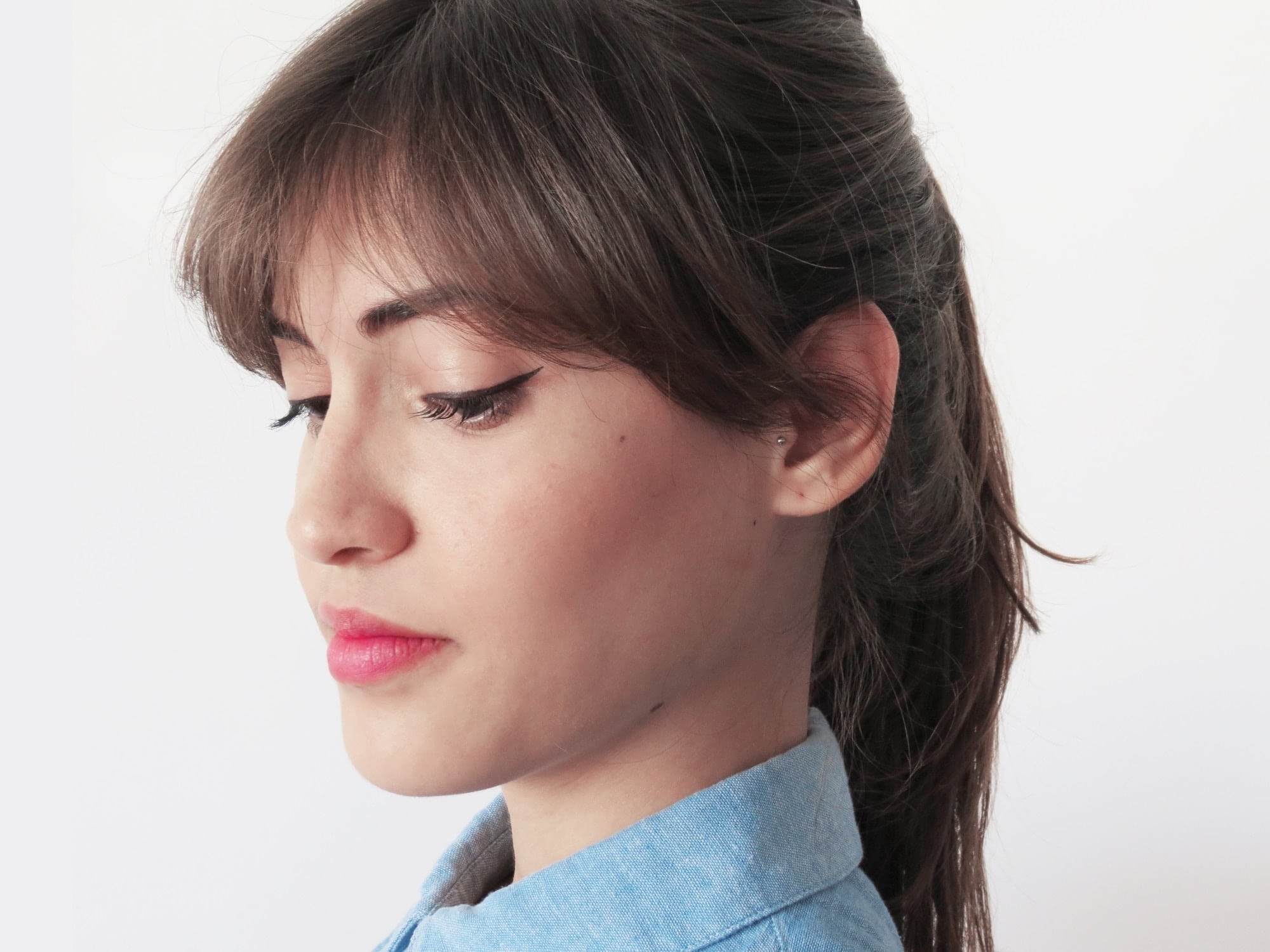 headshot of a woman looking down