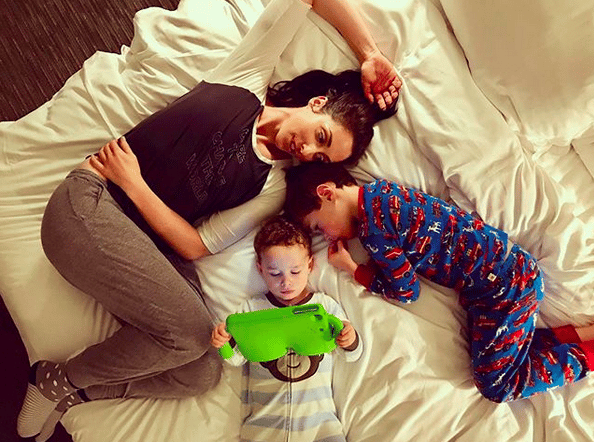 Catherine Reitman sitting with kids on a bed