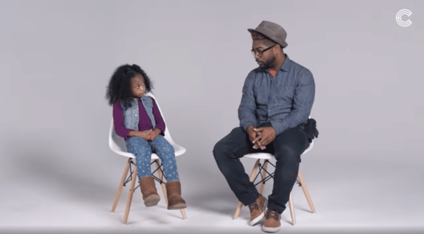 black dad talking to his son