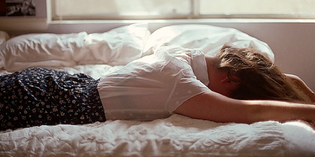 woman laying facedown on the bed