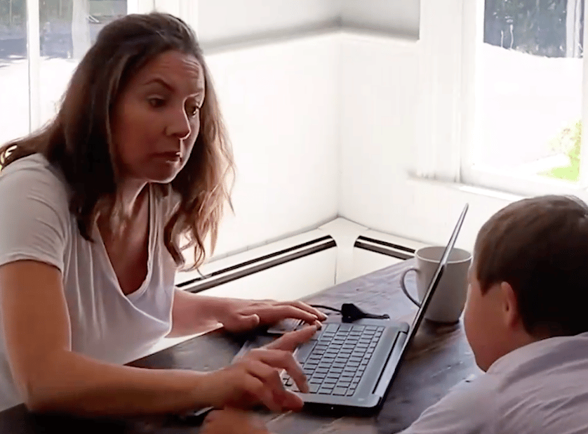 Mom working while child talks to her
