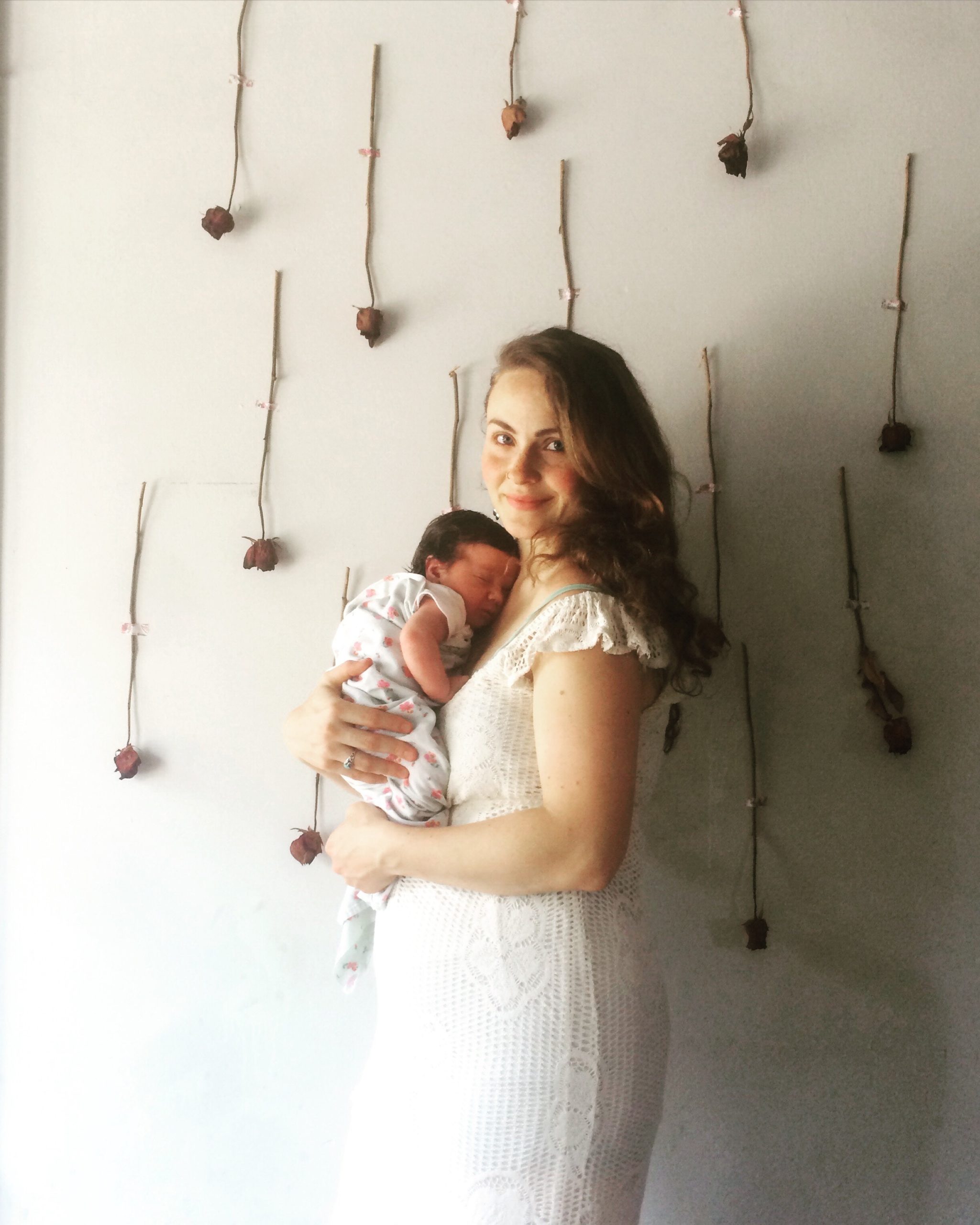 young woman holding a newborn baby