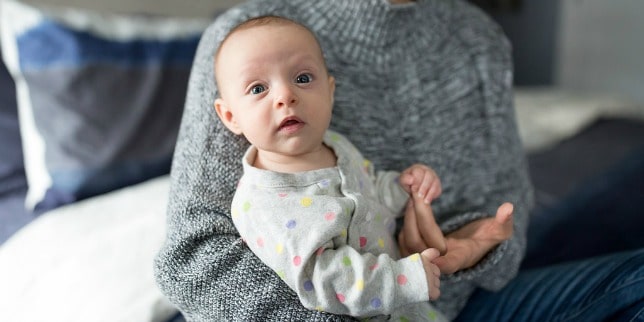 baby sitting in parents lap