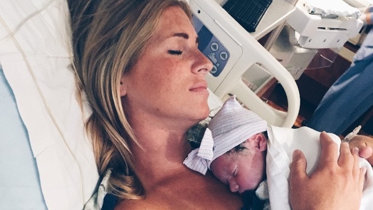 mom holding newborn baby against her chest after having a calm birth