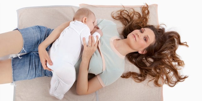 mom with baby sleeping on top of her