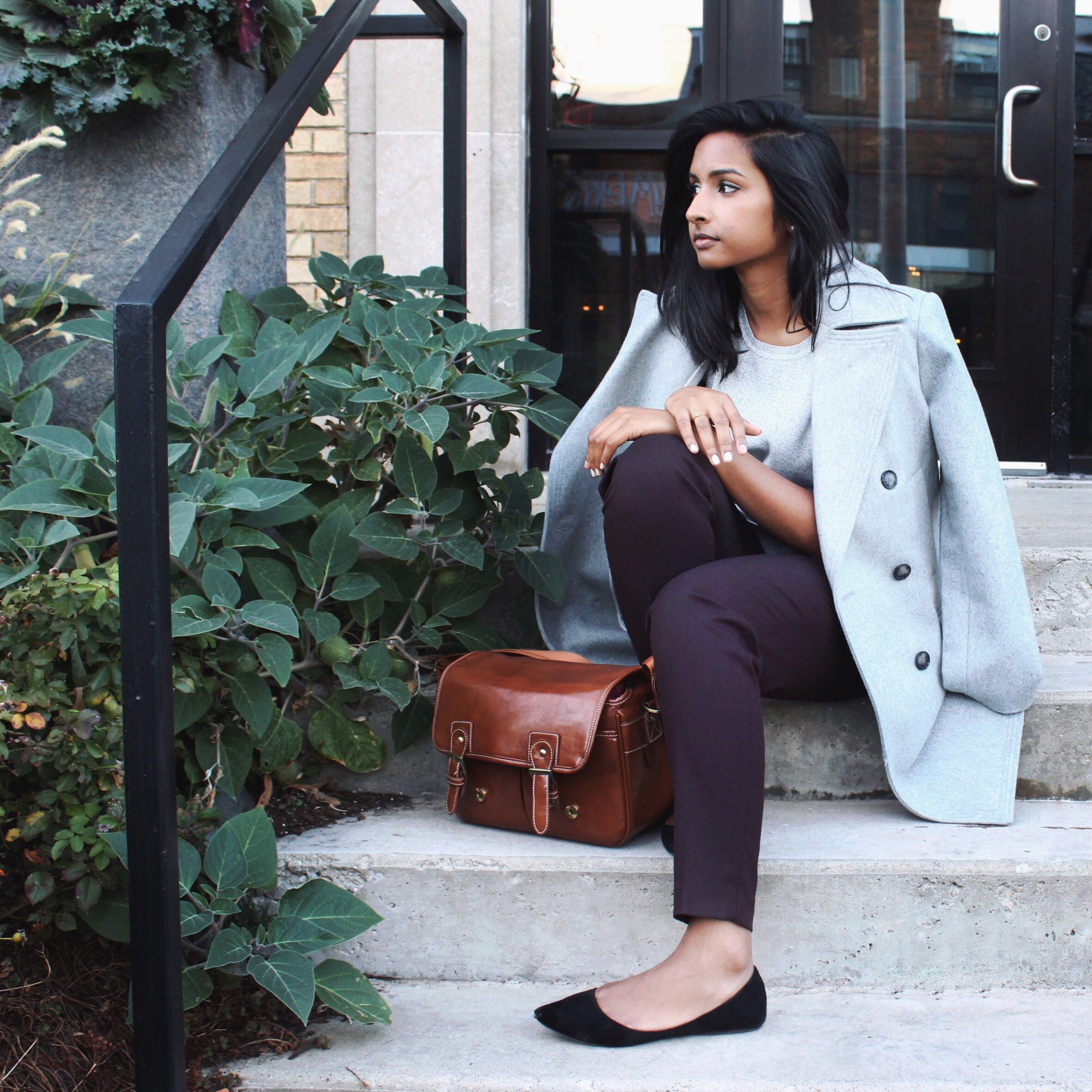 Woman sitting outside on stairs