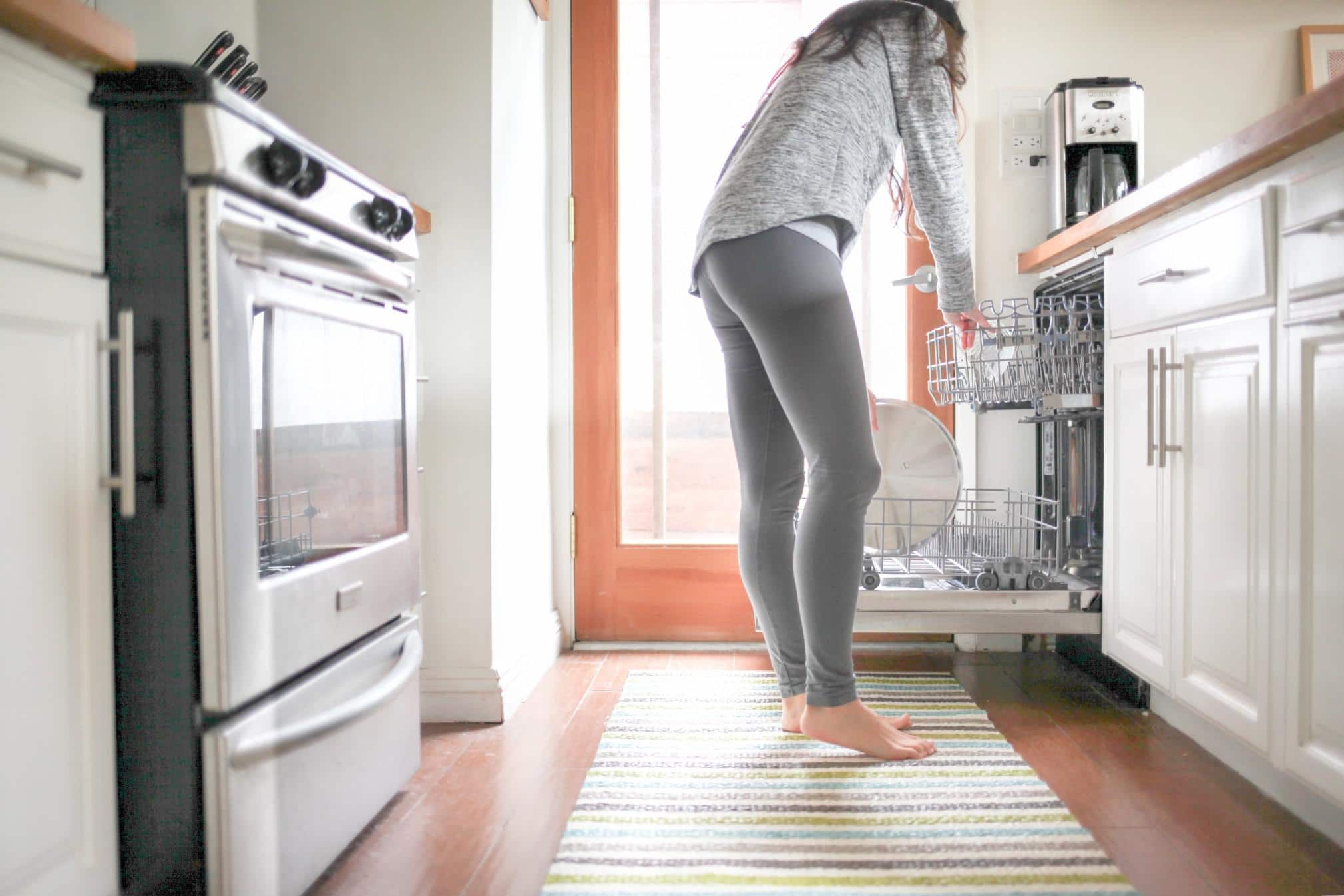 woman unloading the dishwasher