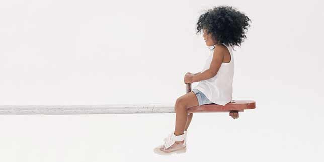 little girl on a seesaw