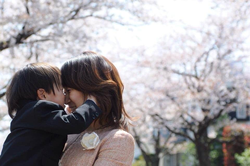 mom kissing son on forehead