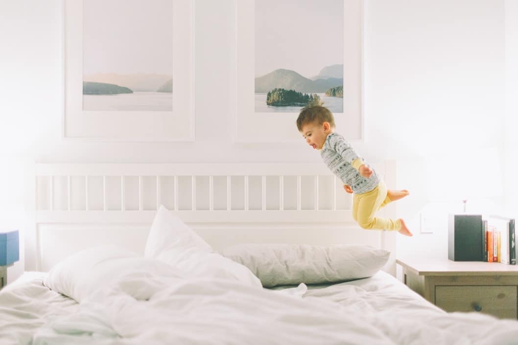 toddler jumping on the bed