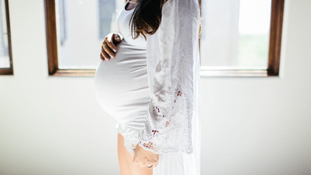 pregnant woman holding stomach