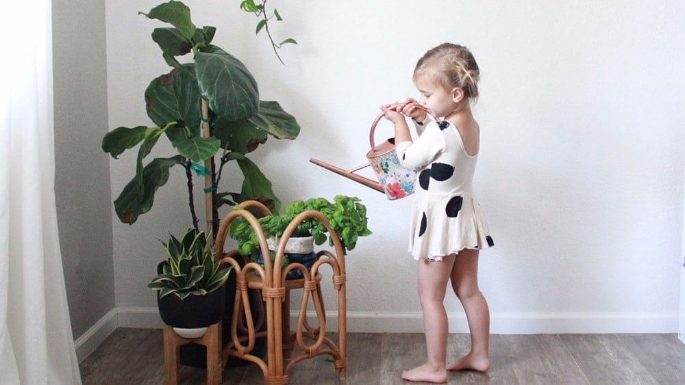 little girl watering plants