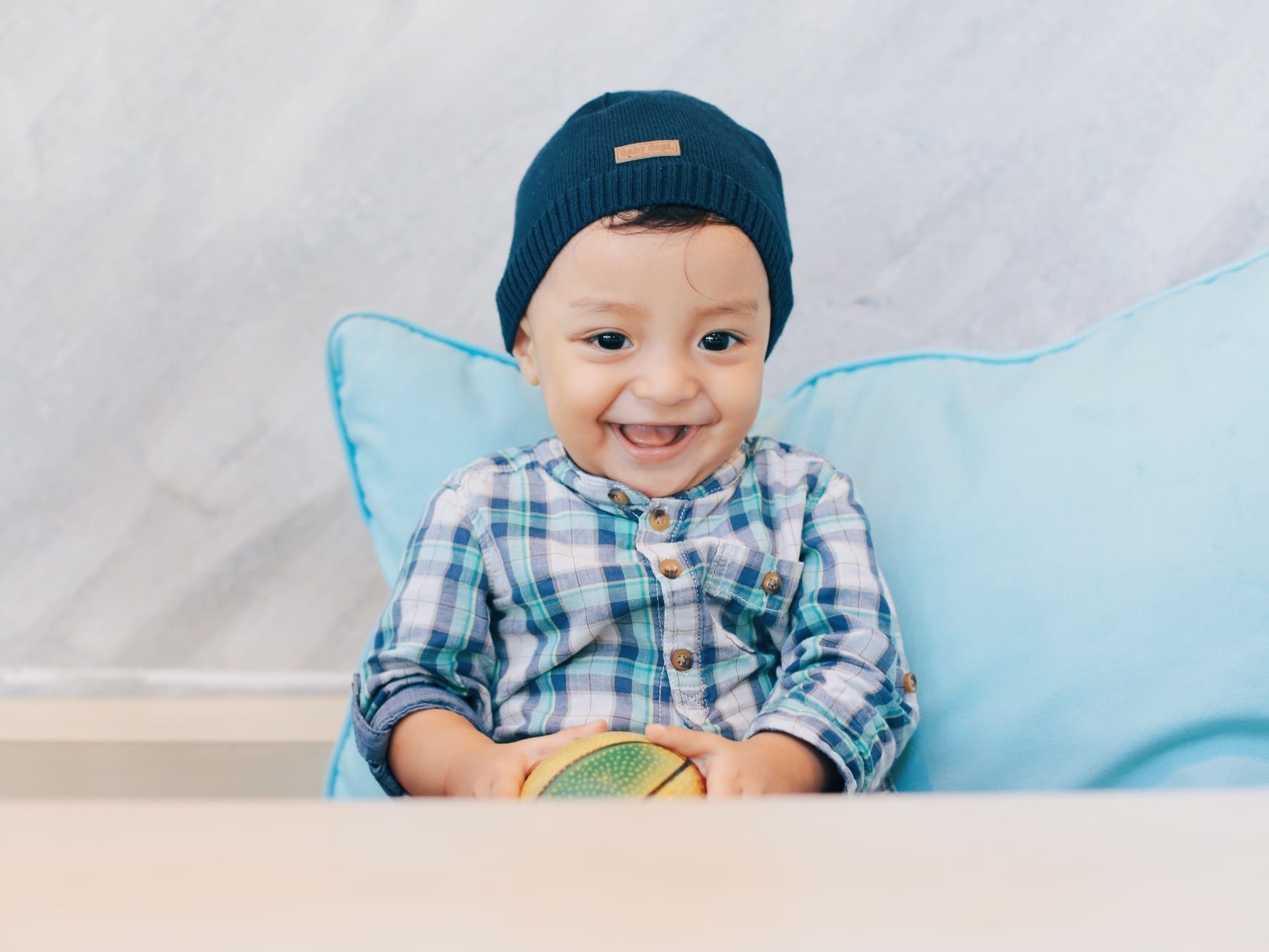 little boy giggling in a chair