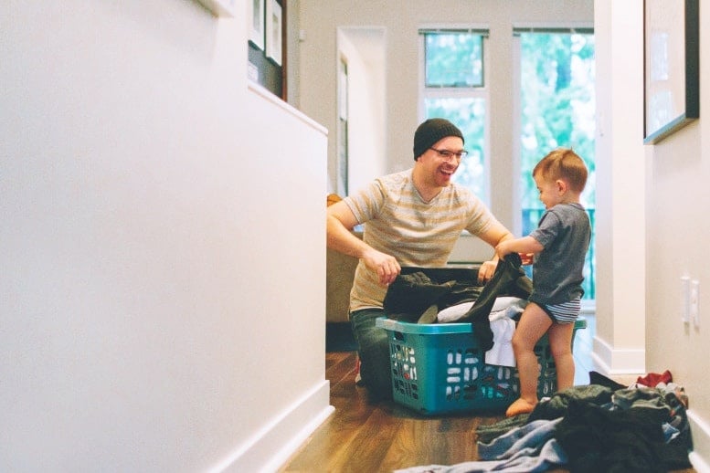 child helping dad in the laundry room
