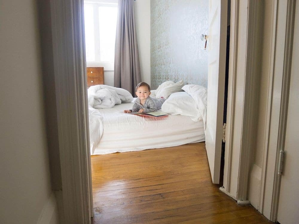 toddler sitting on parents bed