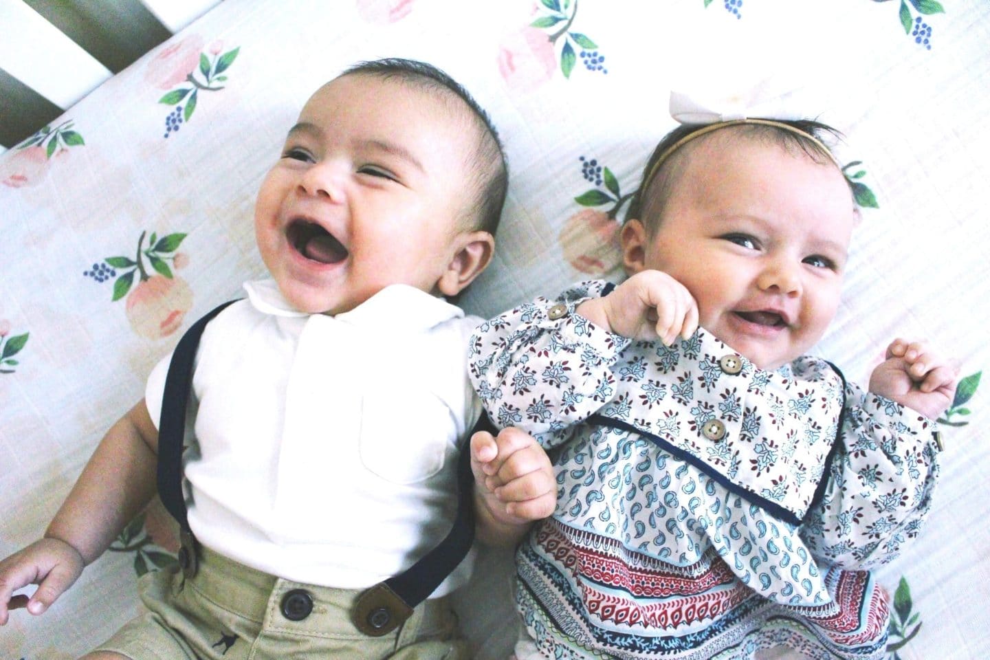 boy and girl baby laying together