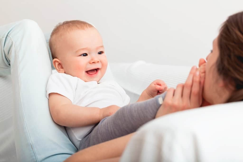 smiling baby on mom's lap