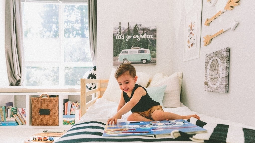 little boy playing on the bed