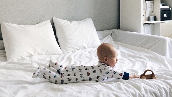 baby reaching for a toy, displaying the montessori milestone of problem-solving skills