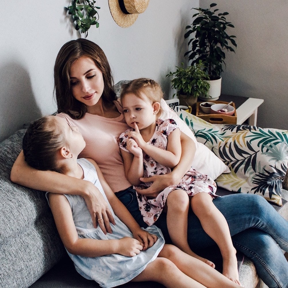 mom hugging two kids