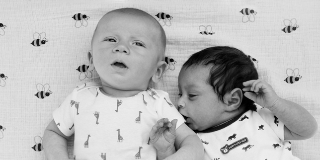 two babies next to each other, learning about social development in infants