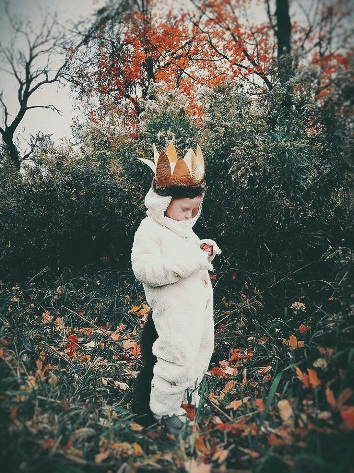 kid playing dress up outside