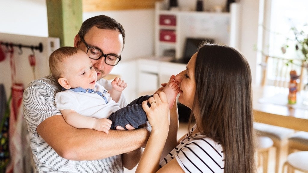 mom and dad playing with baby