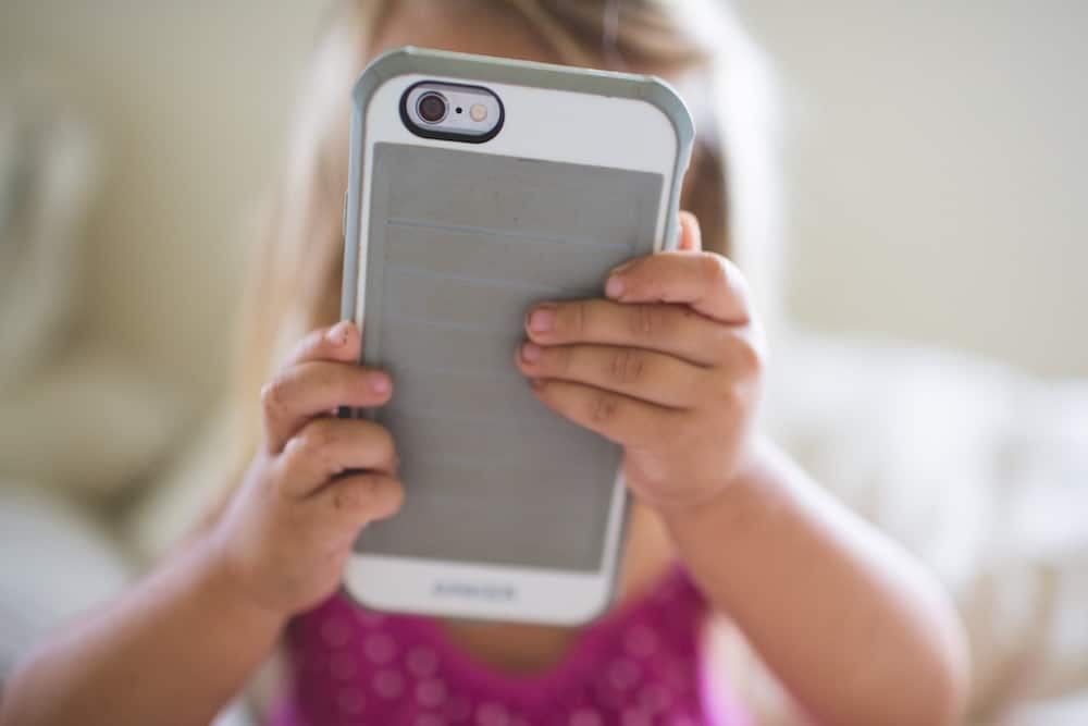 toddler holding iphone up