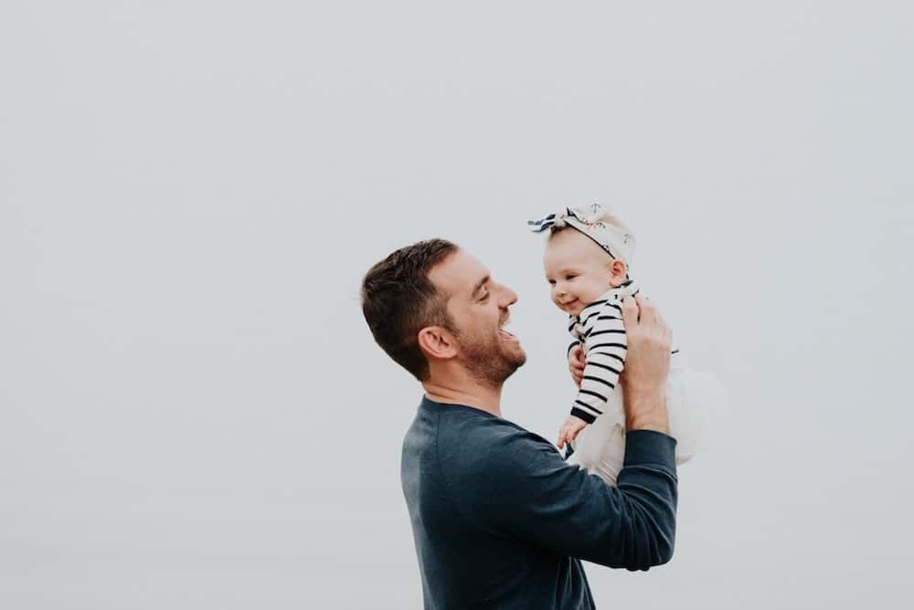 dad holding daughter in the air