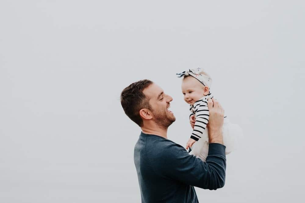 dad holding daughter in the air- how having a daughter changes a man