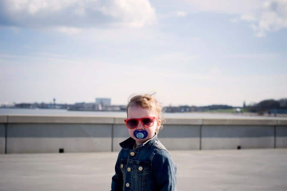 little boy with a pacifier in his mouth